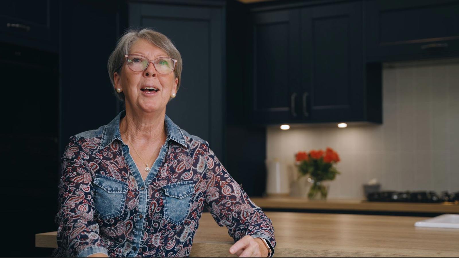 Kitchen remodel recipient Edwina discussing her navy blue kitchen