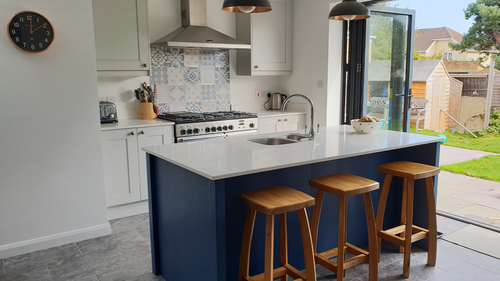Grey shaker kitchen with blue kitchen island