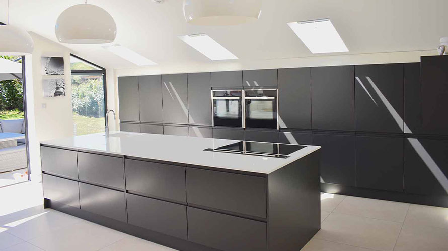 Large kitchen island in a modern dark kitchen