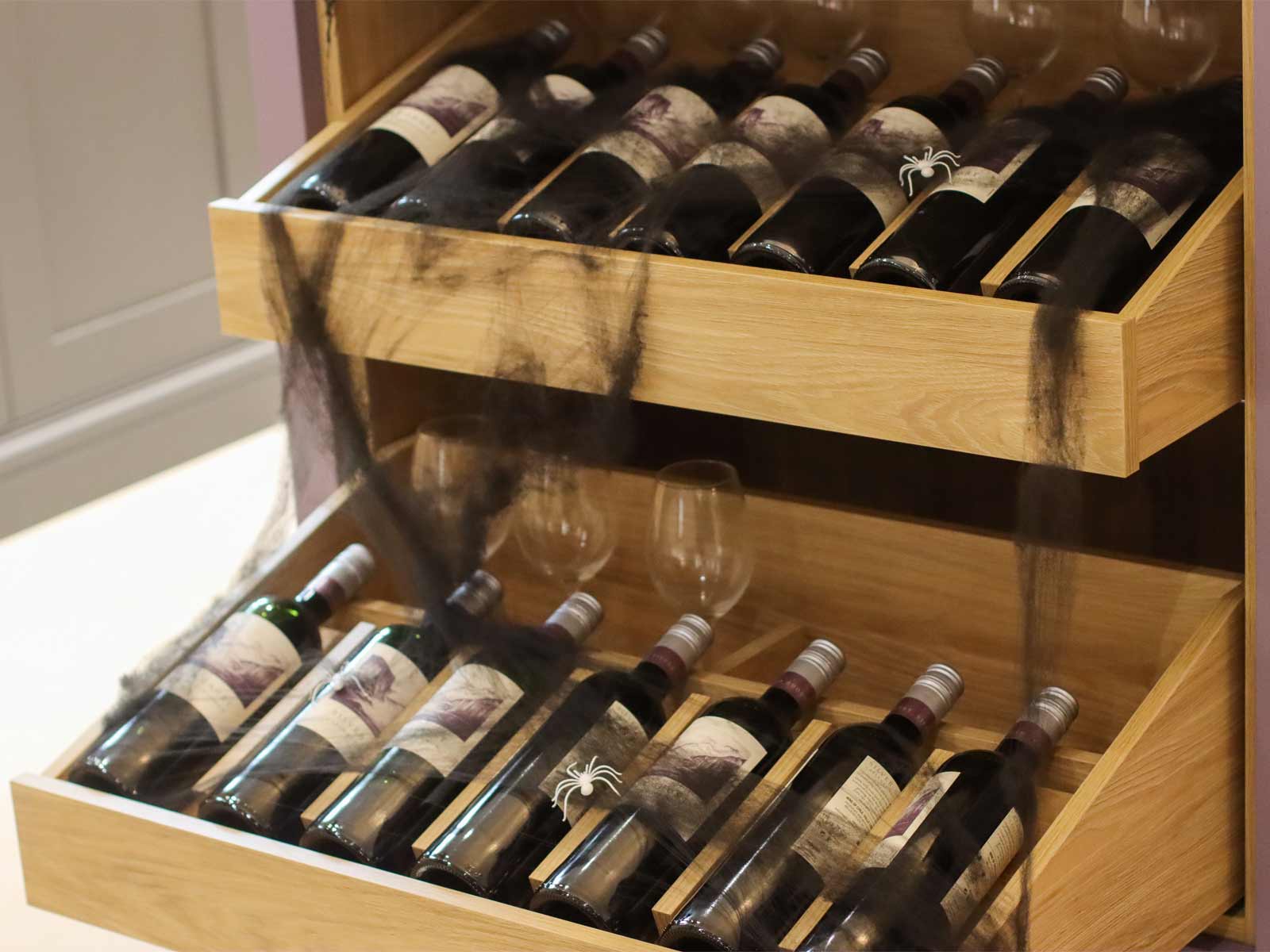 Two shelves for wine bottles including red wine and wine glassware