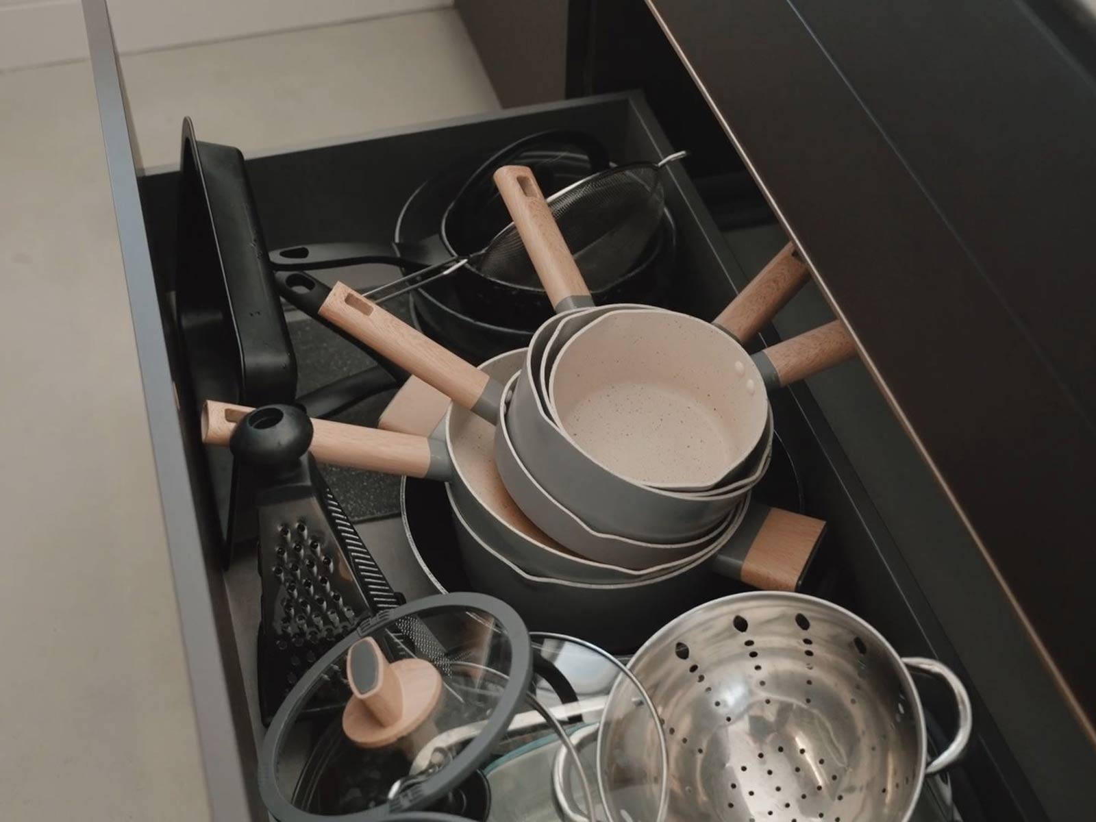 A deep pan drawer in a modern kitchen base unit