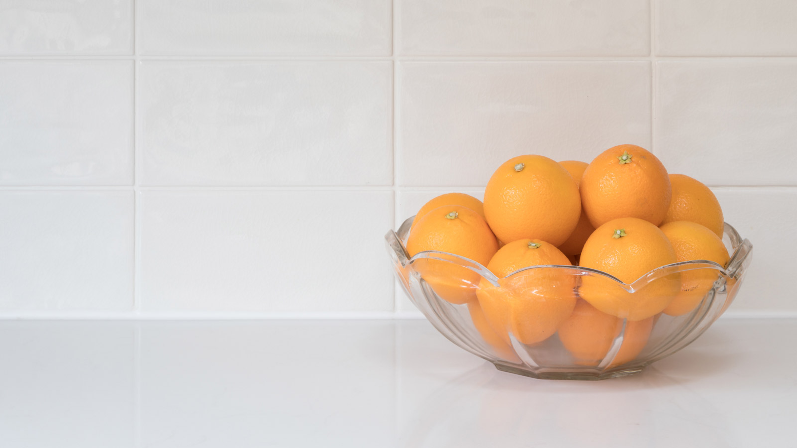 A dish of citrous fruit on a kitchen worktop ready for clove orange pomanders