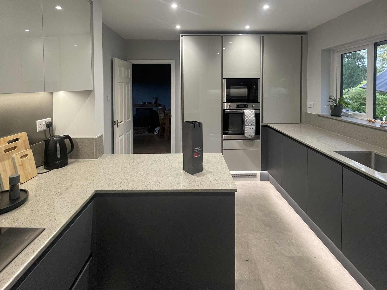 A kitchen with built-in kitchen appliances, including a microwave and oven