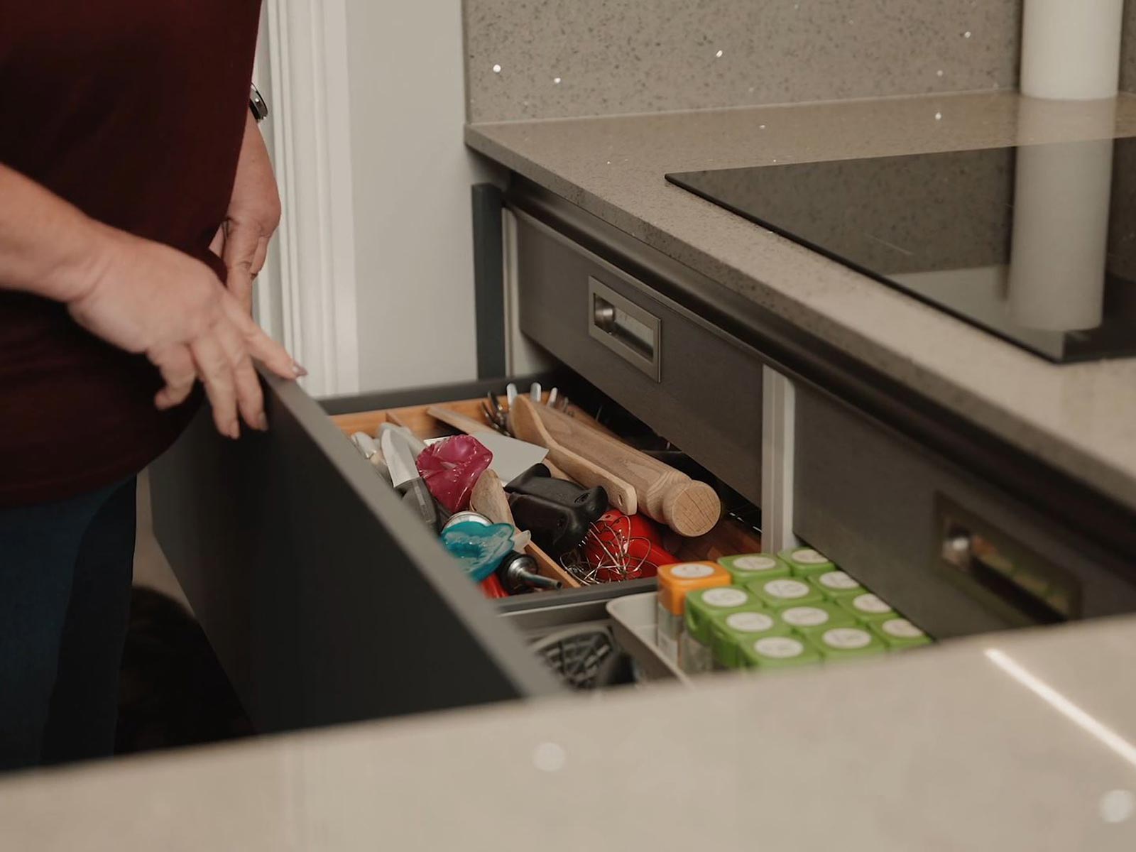 Gail showing kitchen cabinet drawers that use Blum Legrabox drawer boxes