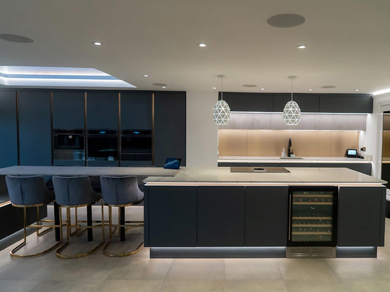 Luxury kitchen with origami lightshades between kitchen wall cabinets