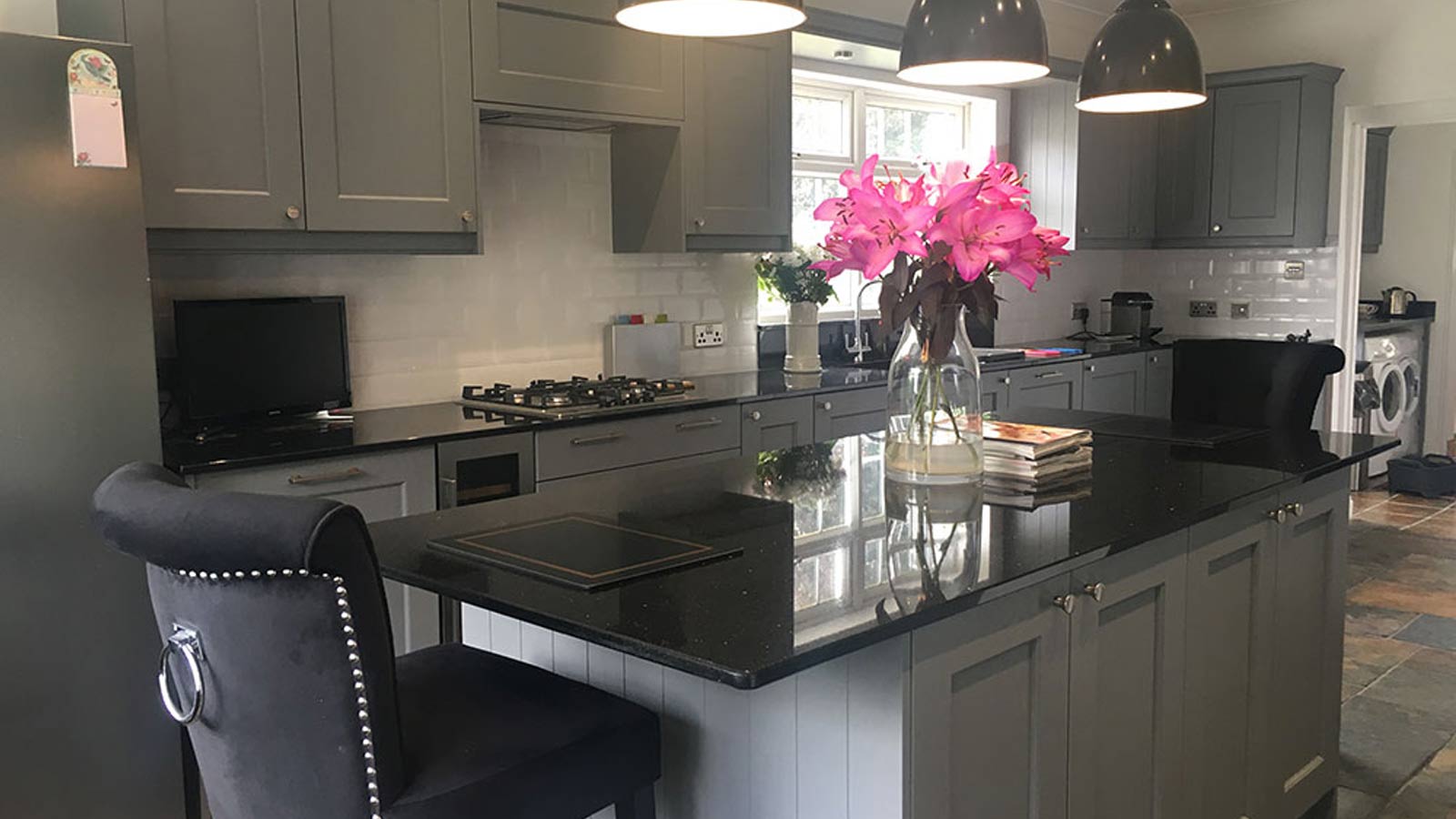 Black, white and grey Shaker kitchen with a mix of kitchen cupboard handles