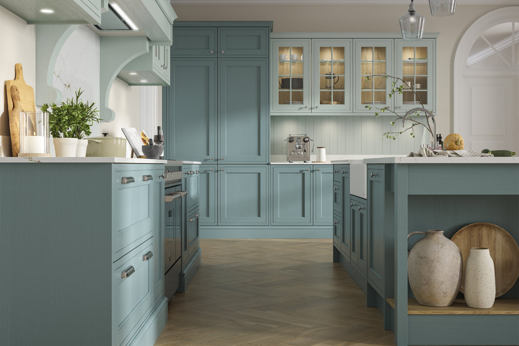 Turquoise green kitchen with faux in-frame doors and white worktops