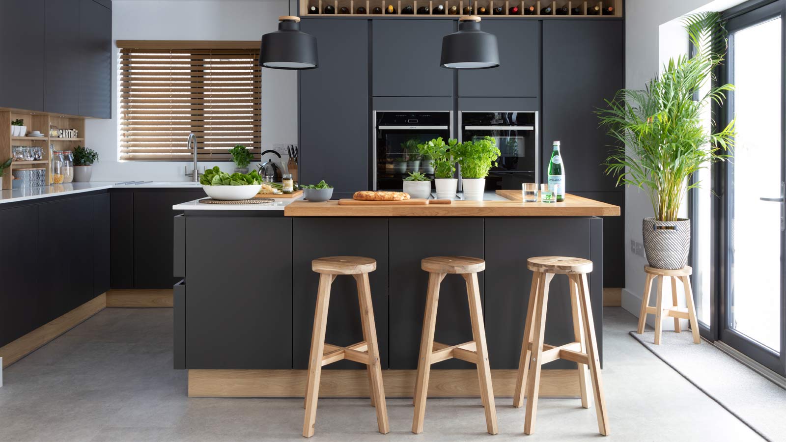 Biophilic interior design in a modern kitchen with wooden barstools