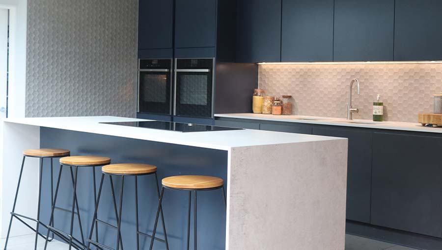 Dark kitchen with blue handleless kitchen doors in Esher