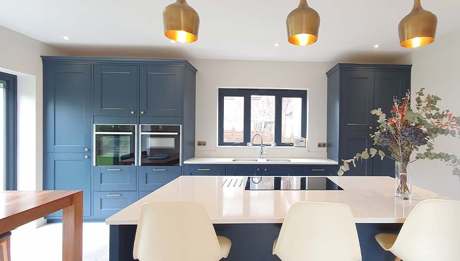 A dark blue shaker kitchen in Cardiff featuring kitchen island