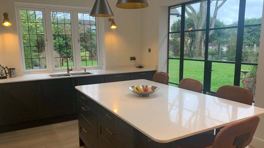 Dark kitchen featuring kitchen island