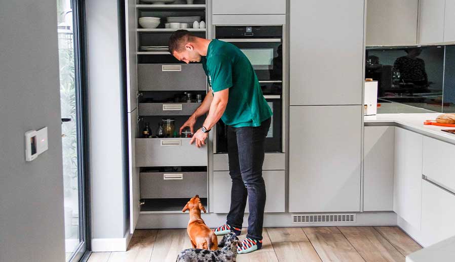 Modern larder unit in a handleless kitchen