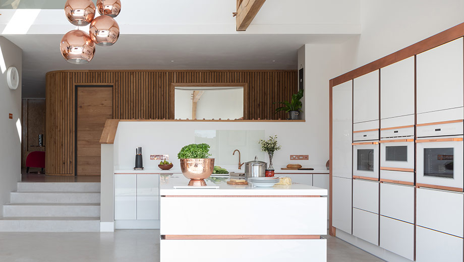 Light grey modern kitchen with rose gold accents