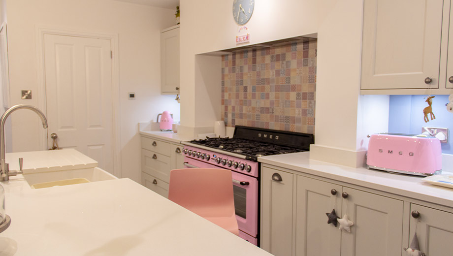 Grey shaker kitchen with pink colour pops
