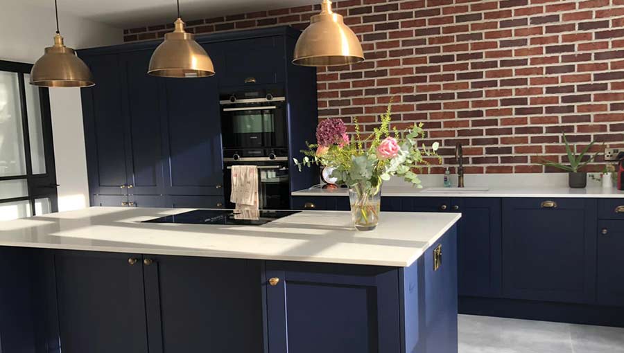 Metallic finishes in a blue shaker kitchen