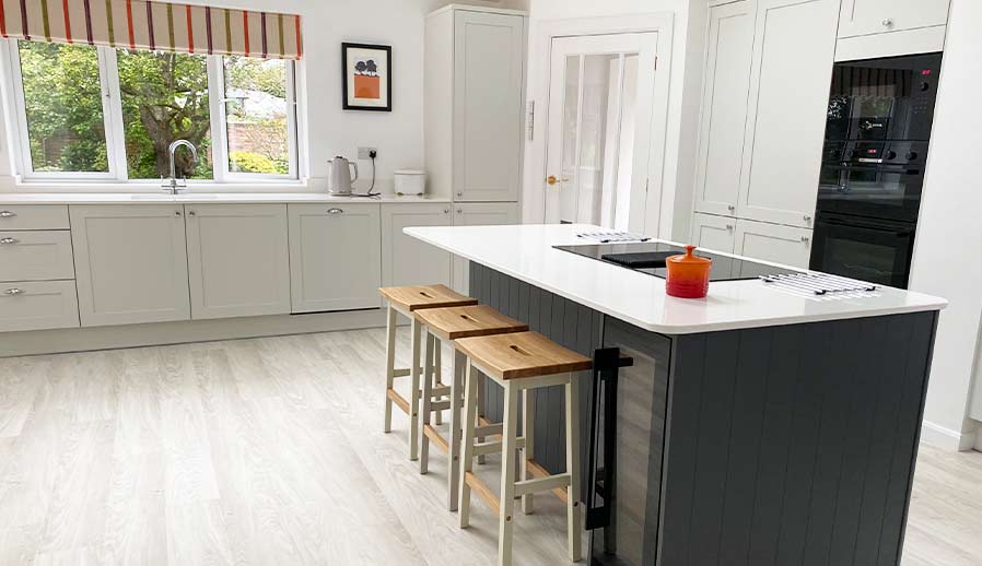 Shaker kitchen in Cardiff featuring kitchen island and bench seating