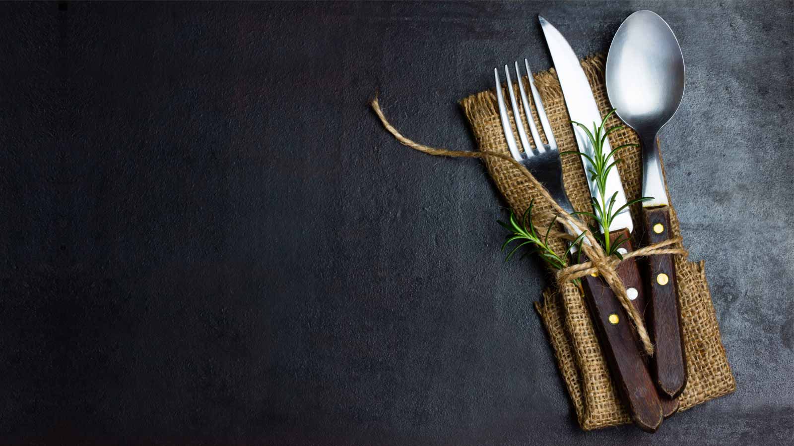 Food festival cutlery wrapped in herbs and twine that match the expensive kitchen look