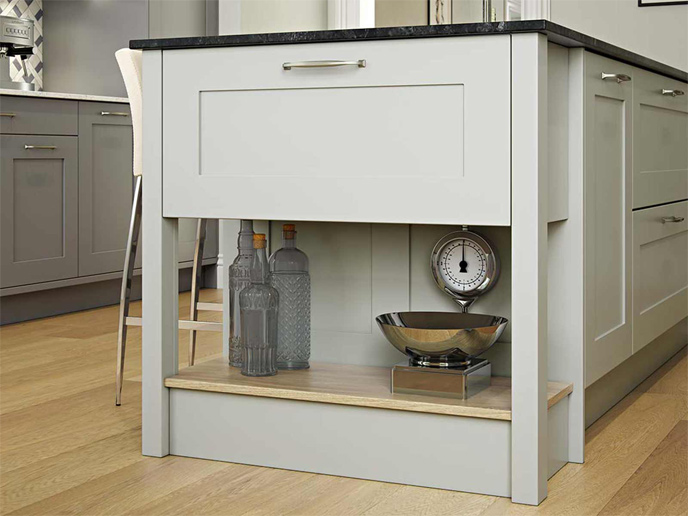 Pale green kitchen island with a Midnight Pietra top and matching chef’s table