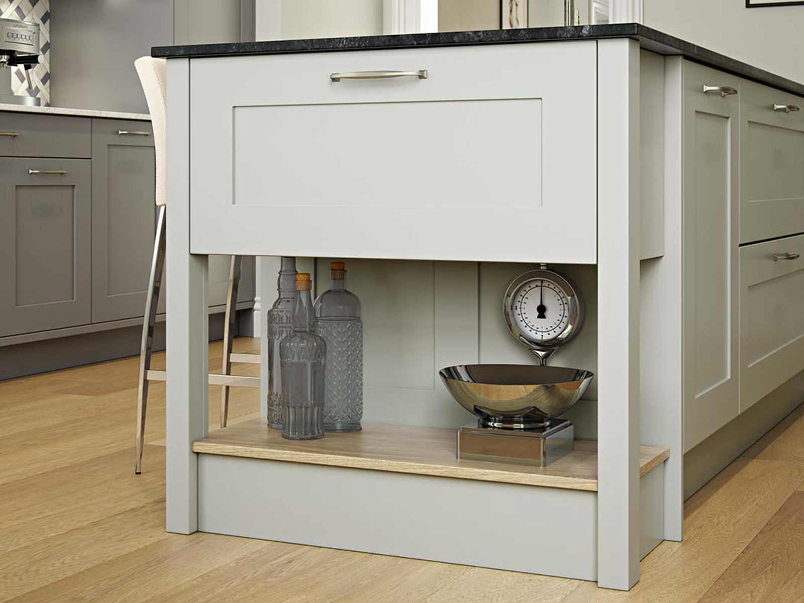 Pale green kitchen island with a Midnight Pietra top and matching chef’s table