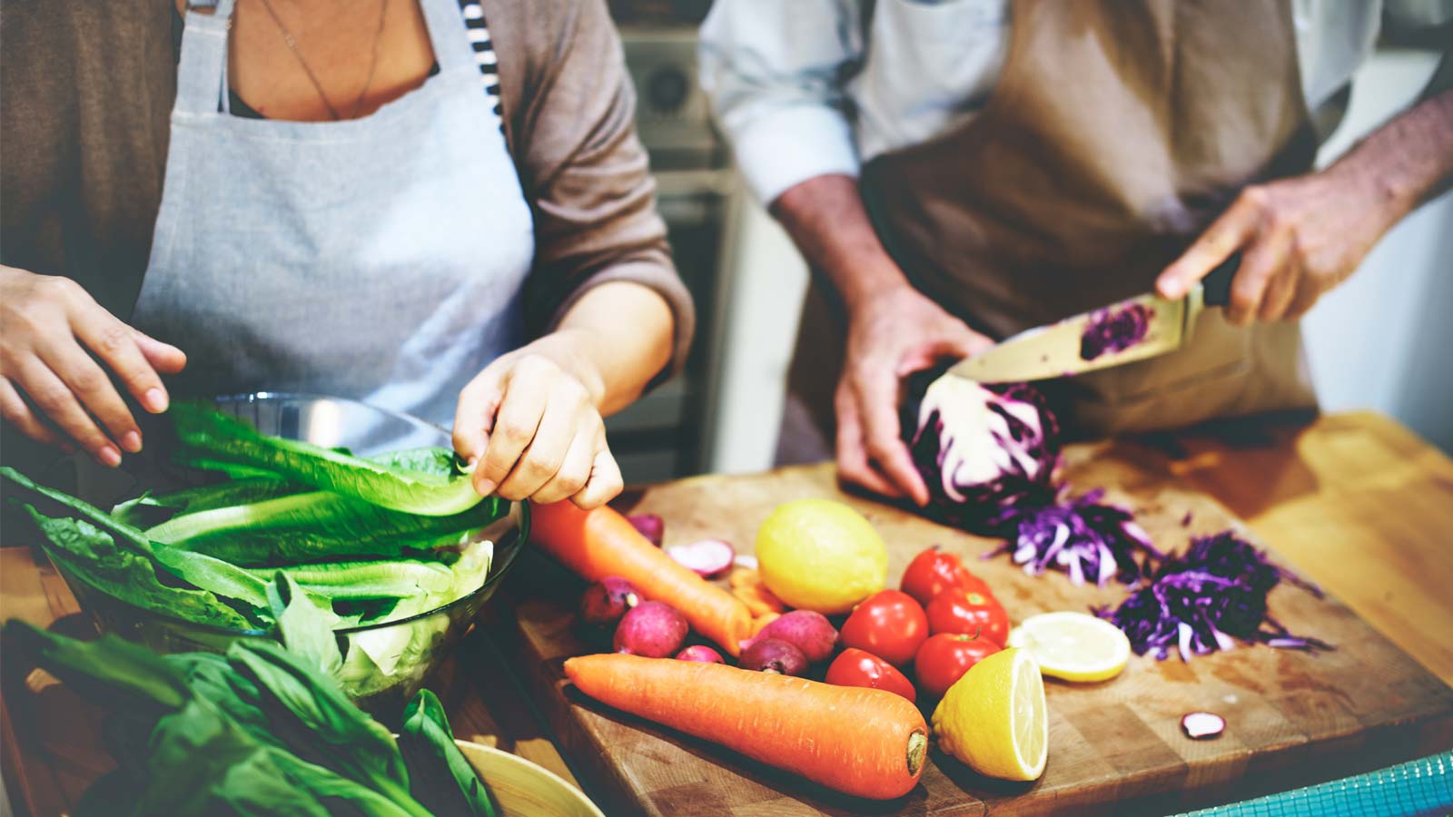 Relatives cutting fruit and vegetables in a kitchen for Ramadan iftar time