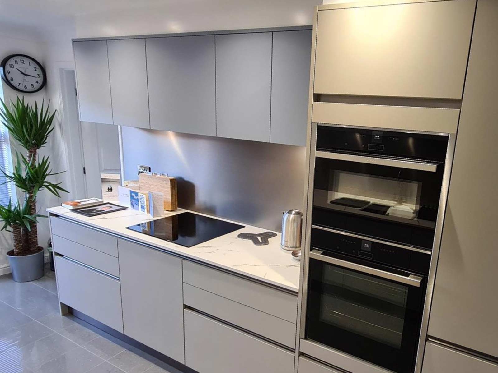 A matt cashmere kitchen with pale grey and powder blue cabinet doors