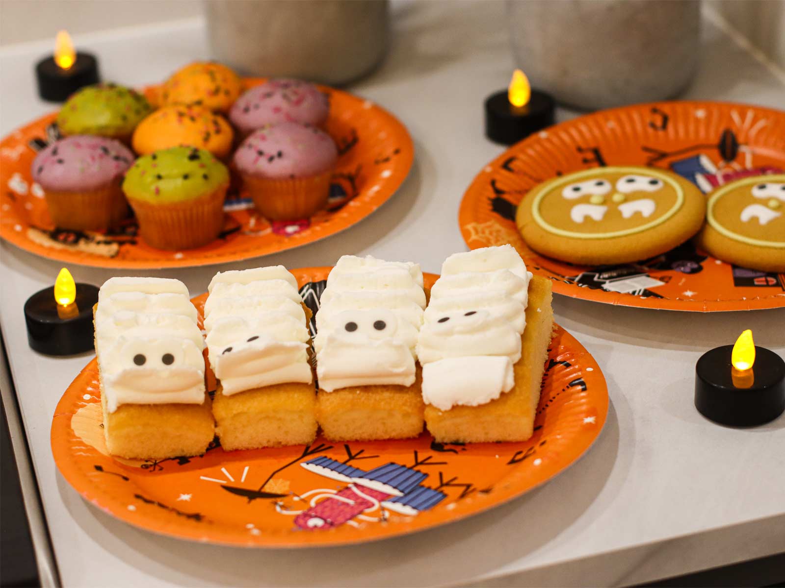Halloween party treats for kids, including cupcakes and biscuits