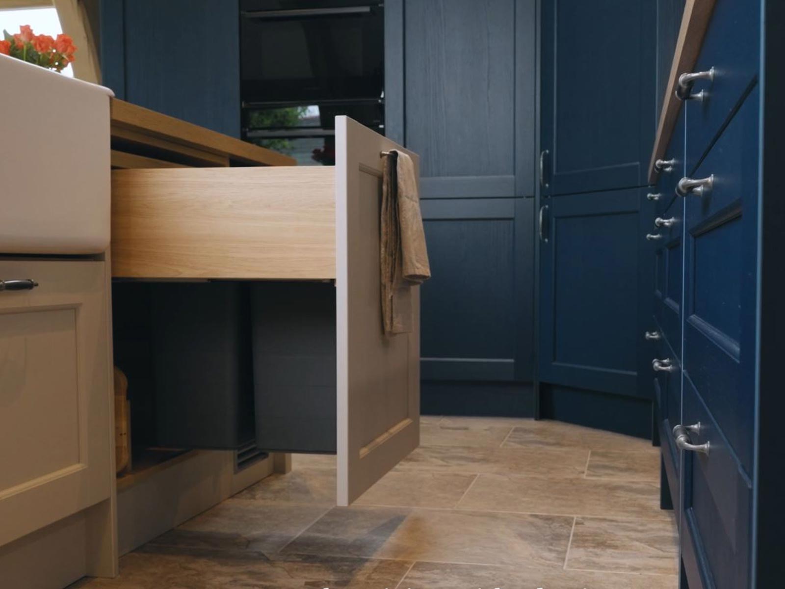 A kitchen compost bin inside a kitchen bin double unit