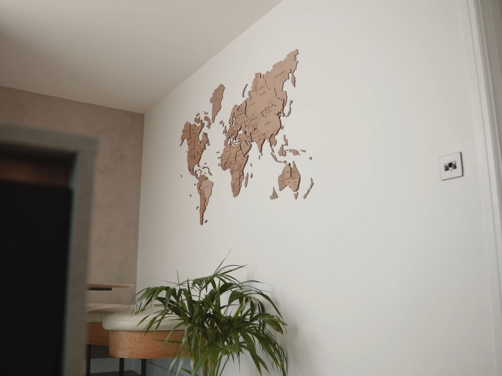 Modern kitchen design decorations, including a wall map and a kitchen plant
