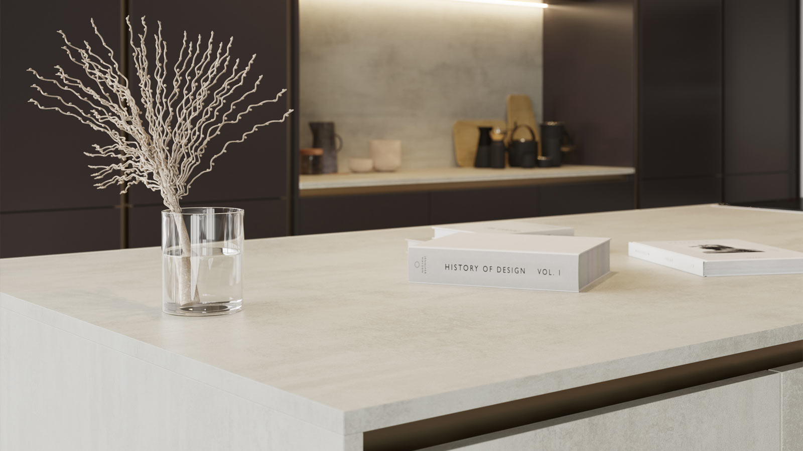 A soft minimalist, white stone-effect kitchen island unit with coffee table books