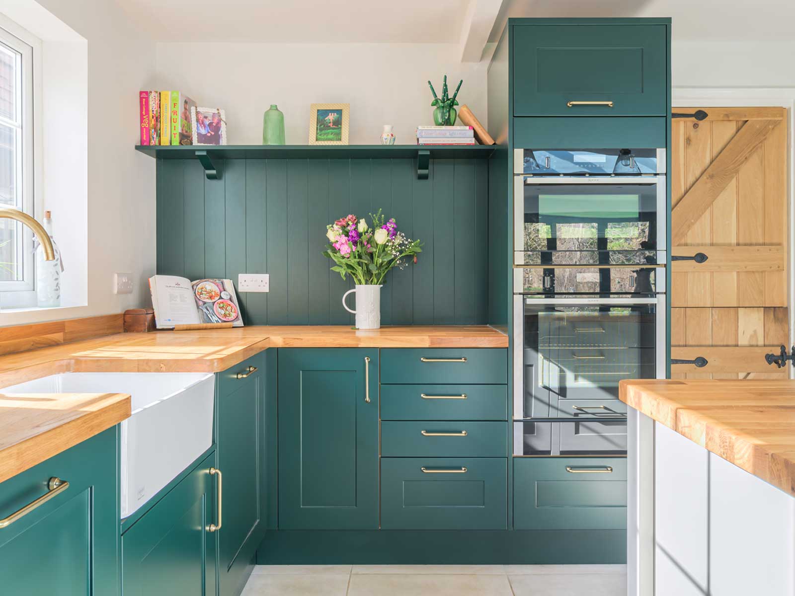 Kitschy kitchen with dark green kitchen paint and eclectic kitchen décor