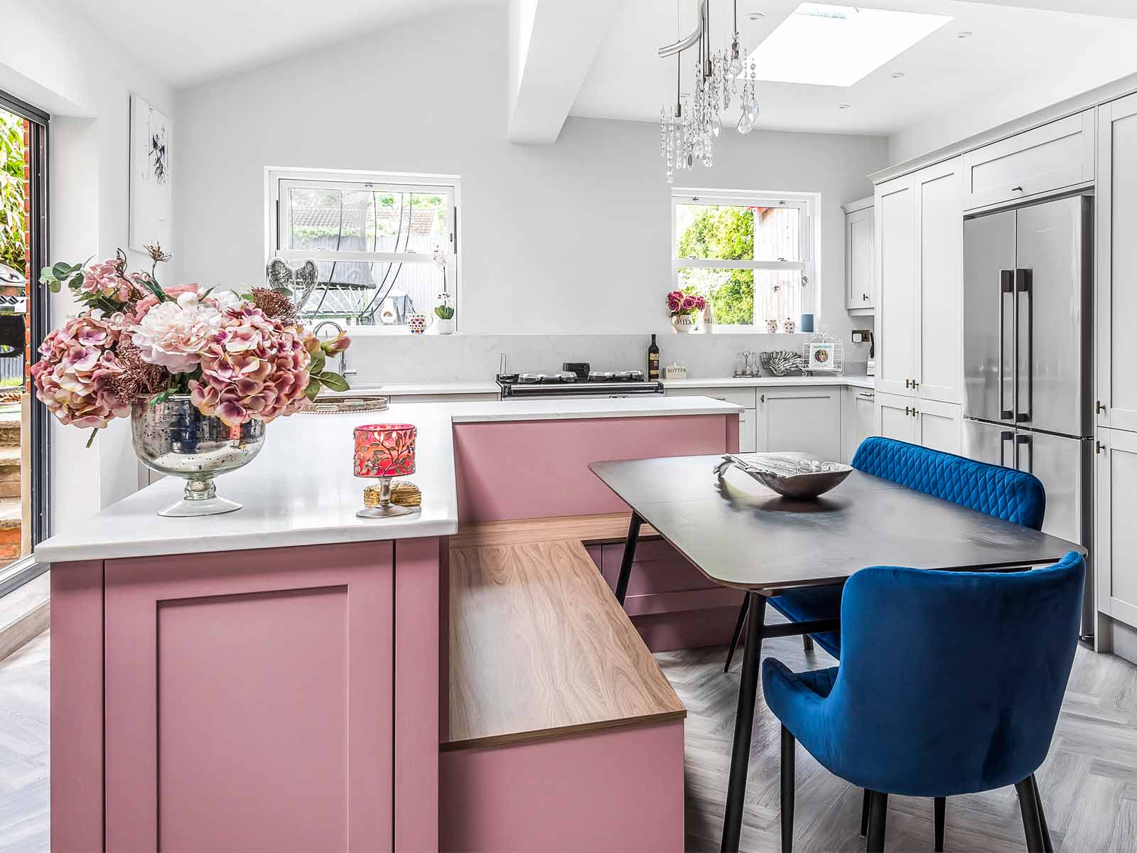 Floral kitsch kitchen decorations atop a pink and blue kitchen dining set-up