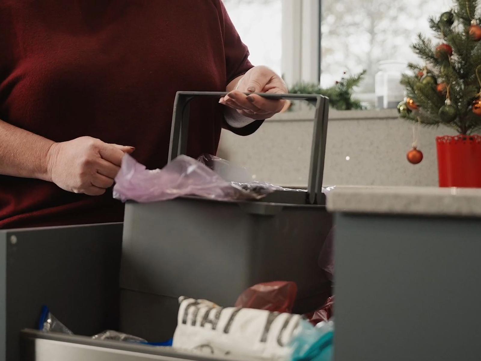 A kitchen bin with recycling aids and kitchen bin dual handles