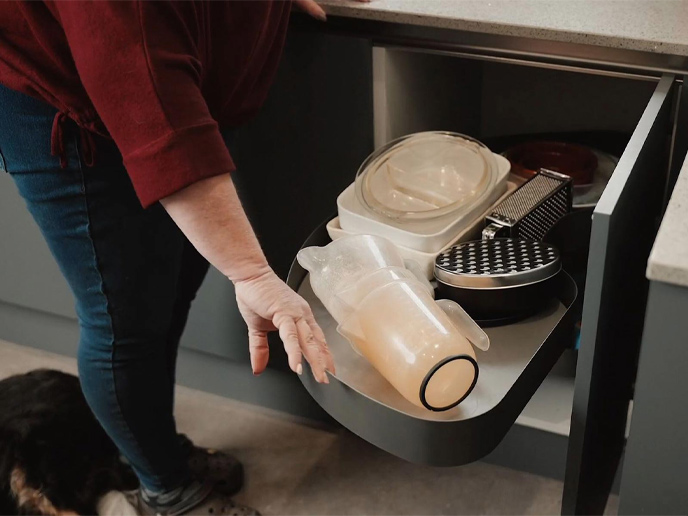 Gail pulling a LeMans metal storage drawer from a corner