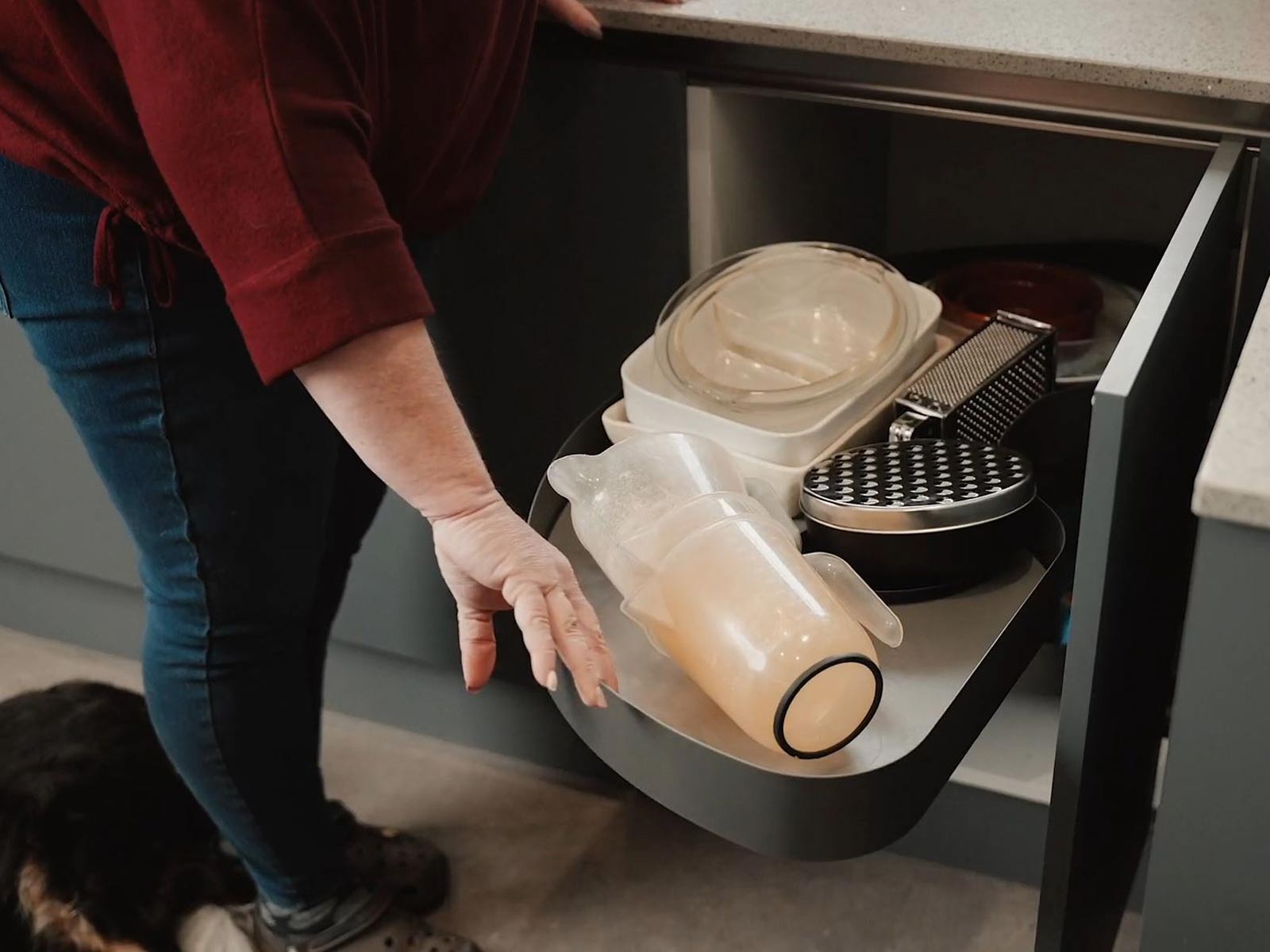 Gail pulling a LeMans metal storage drawer from a corner