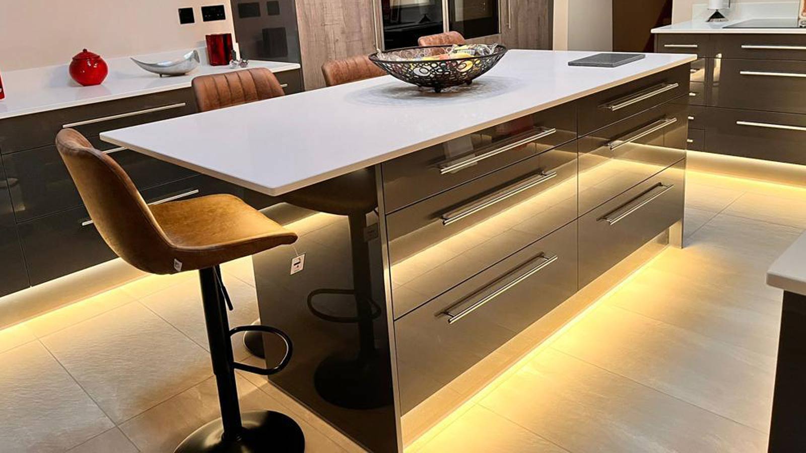 A posh kitchen setup in a modern style with a black and white kitchen island