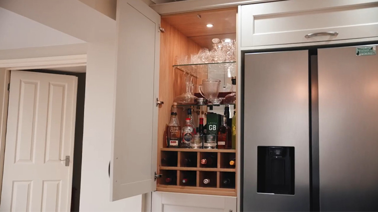 A tall cocktail cabinet in an open-plan kitchen living room