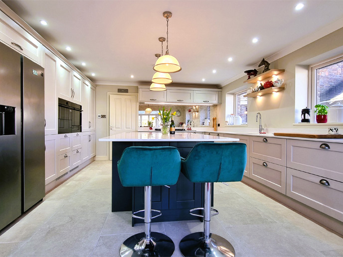 An open kitchen with a kitchen island with stools