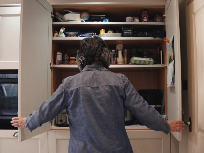 Rita opening the pantry in her family kitchen room