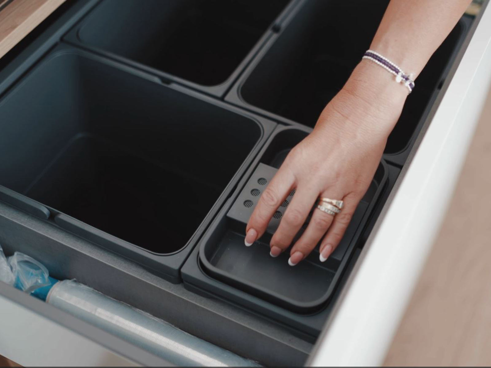 A kitchen bin drawer built into a kitchen storage cabinet