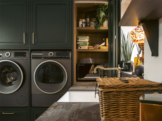 A dark green utility room with a Belfast sink