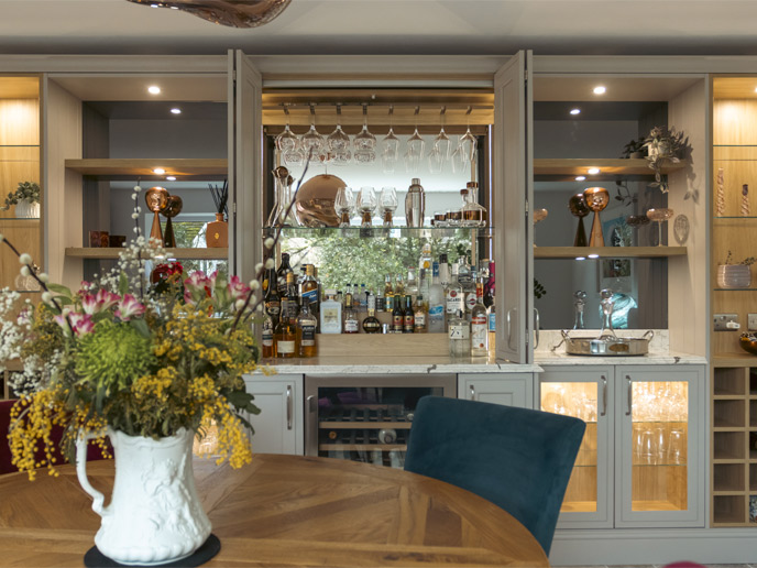 A stocked bar dresser with a mirrored background