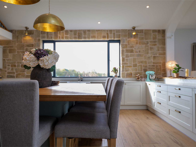A bar conversion kitchen featuring a closeup on a kitchen island wood worktop