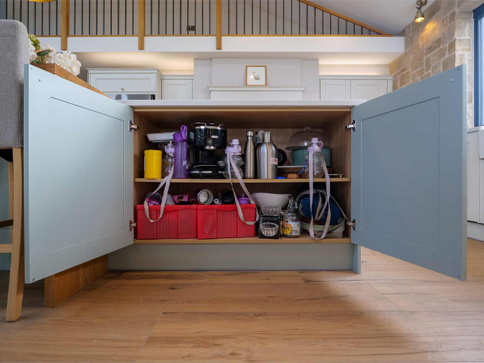 An extra-wide kitchen cabinet built into a barn-conversion kitchen’s island