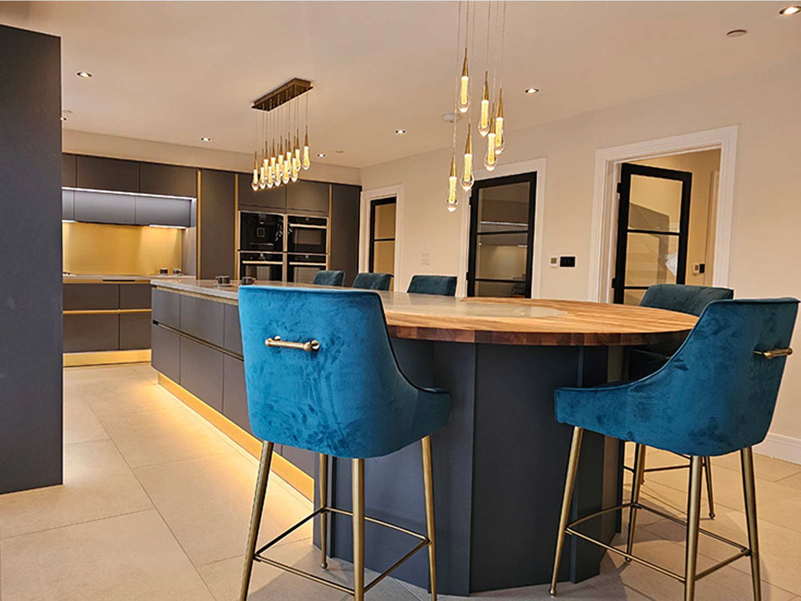 A kitchen remodel idea example with a copper splashback and wooden worktop