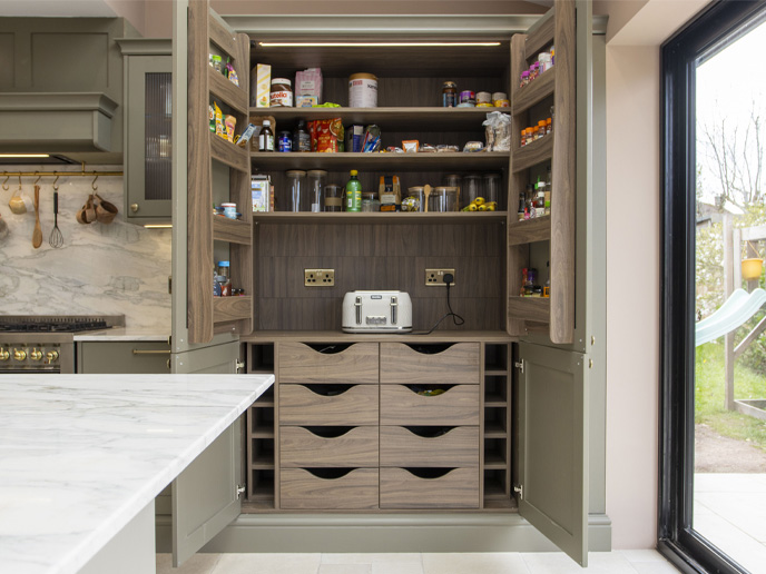 A grand pantry in a dark wood kitchen