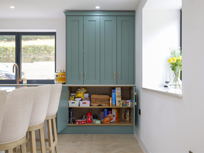 A large kitchen dresser with wide open cupboards without a center post