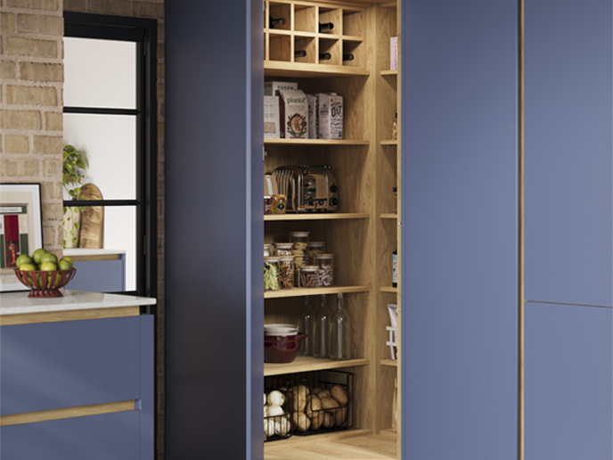 A handleless corner pantry with matching wood internals and handlerails