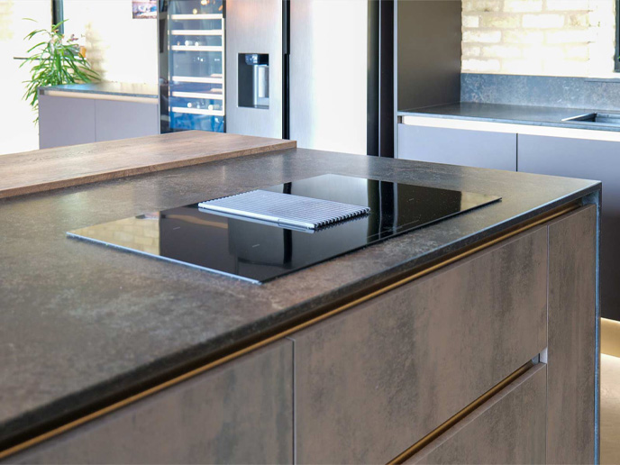 A modern Grand Designs kitchen including an extractor hob