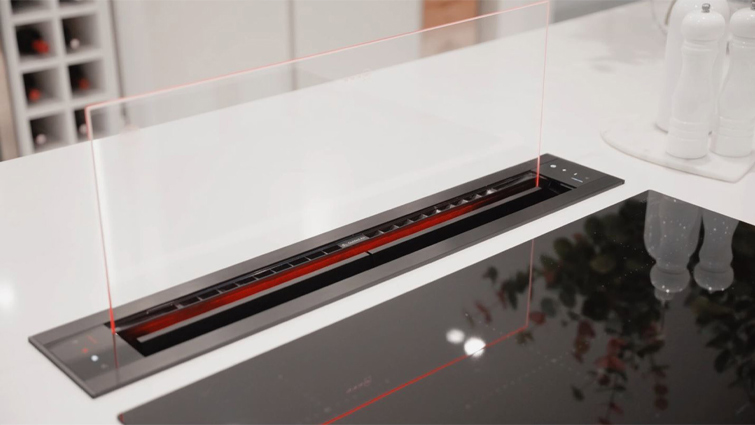 A childproof gas stove with a commercial kitchen appliance built into an oven