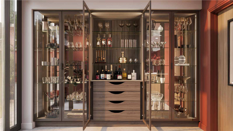 A luxury pantry with glass doors and dark wood drawers